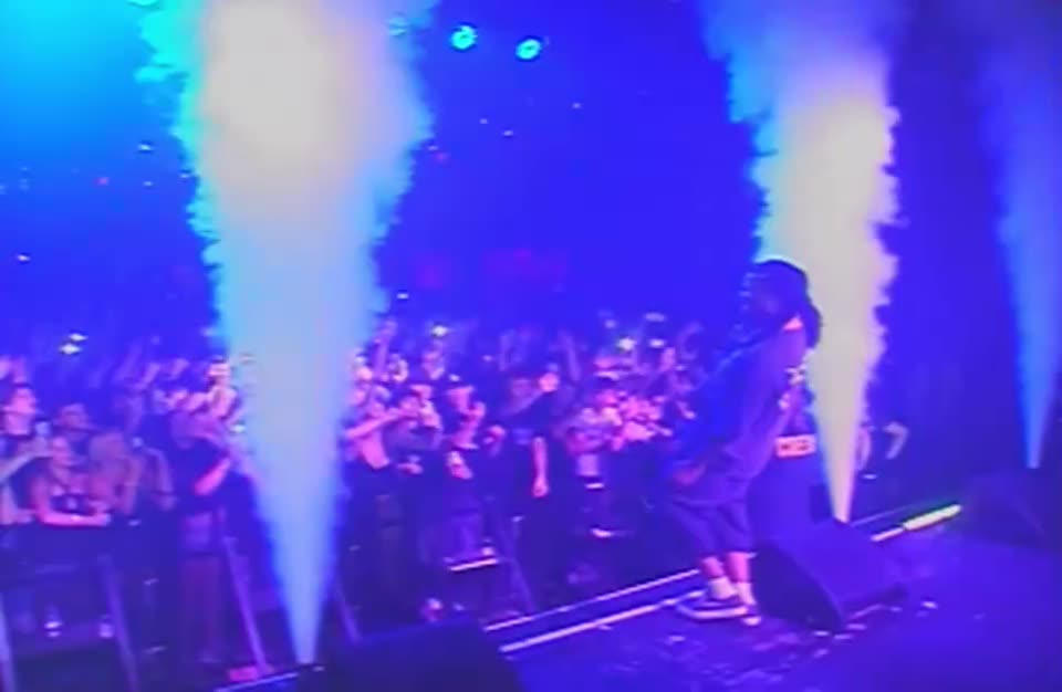 Twin CO2 jets on a blue-lit stage over the crowd